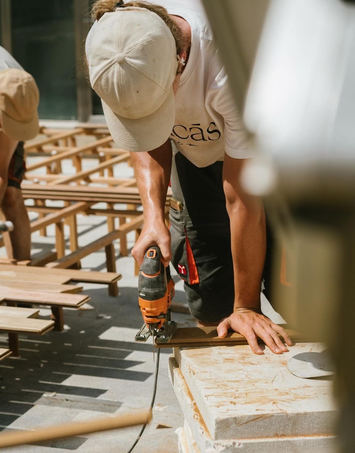 Tradesperson cutting timber on site